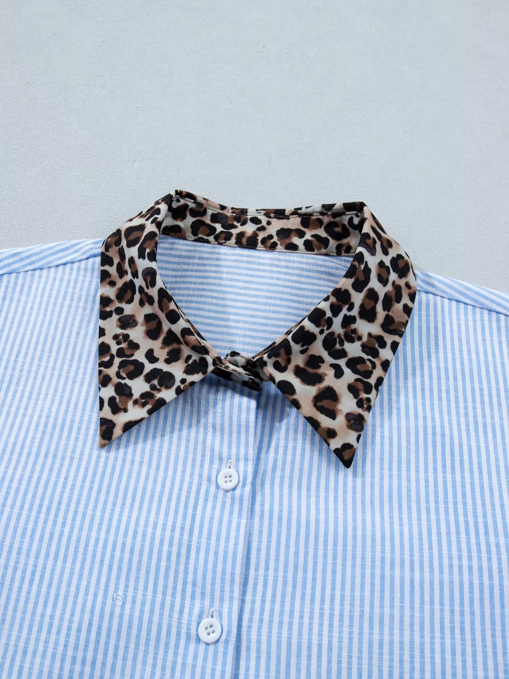 Women's leopard print short sleeve dress with contrast collar by Trendsi, featuring a stylish animal print and contrasting neckline.