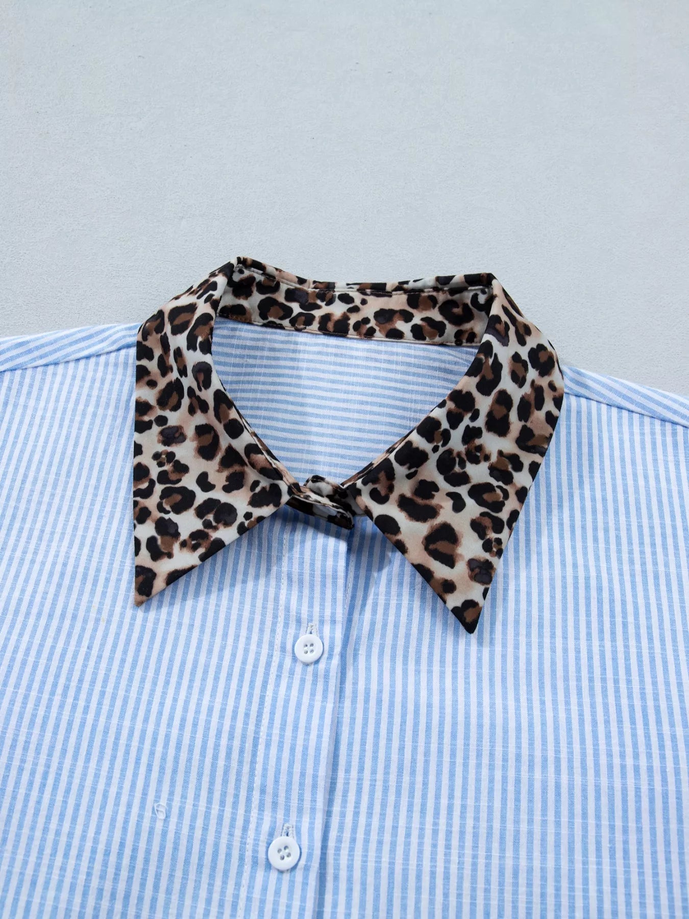 Women's leopard print short sleeve dress with contrast collar by Trendsi, featuring a stylish animal print and contrasting neckline.