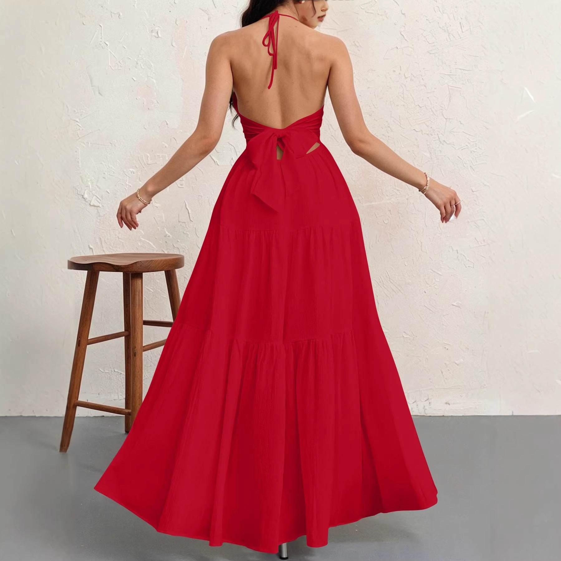 Backless halterneck v-neck pleated A-line dress for women by Plush Fashion Hub, shown on a hanger against a neutral background.