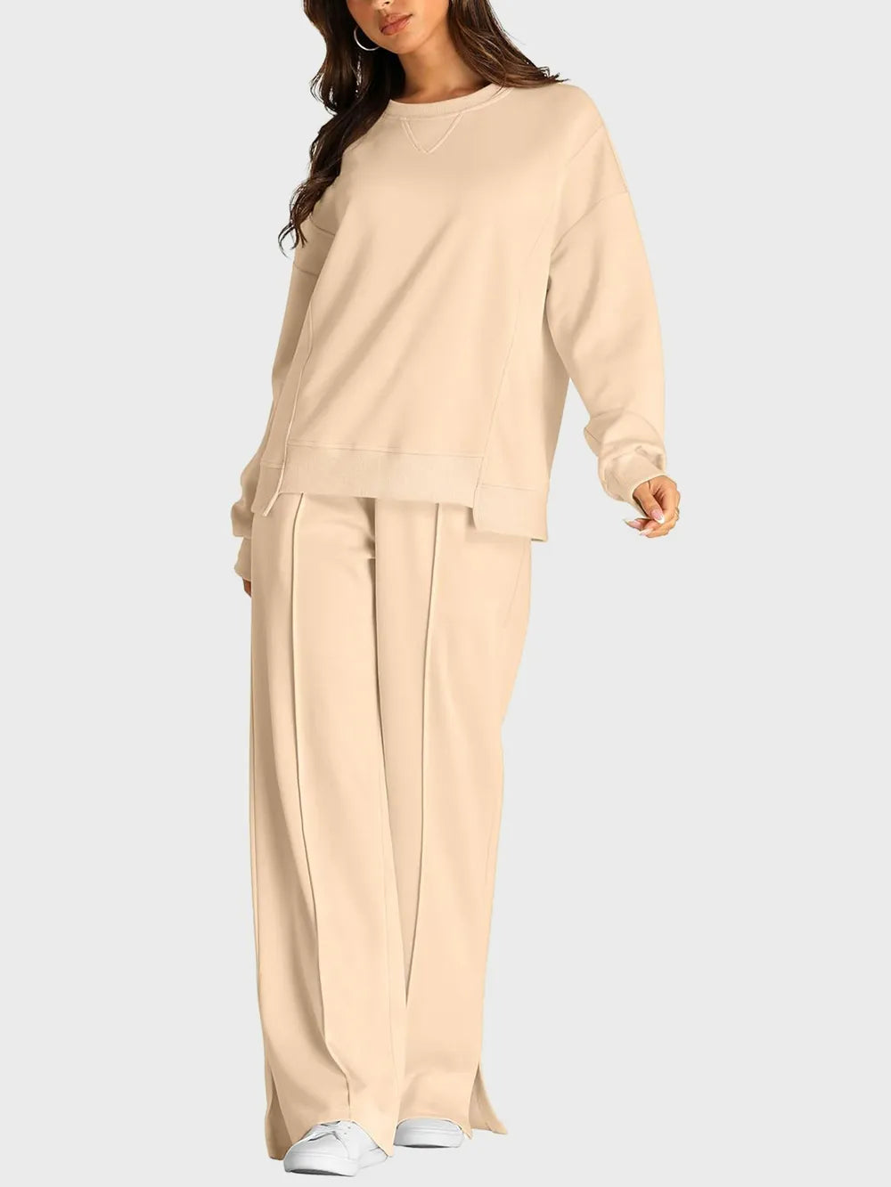 Trendsi round neck long sleeve top and slit pants set, stylish matching outfit, with a fitted long sleeve top and wide slit pants.