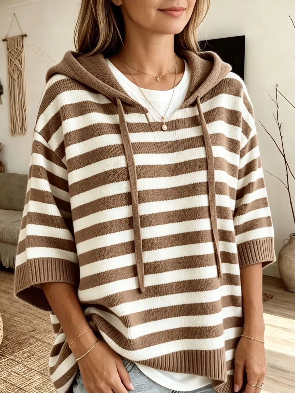 Plus size striped hoodie sweater with drawstring hood from Trendsi, featuring a relaxed fit and bold horizontal stripes.
