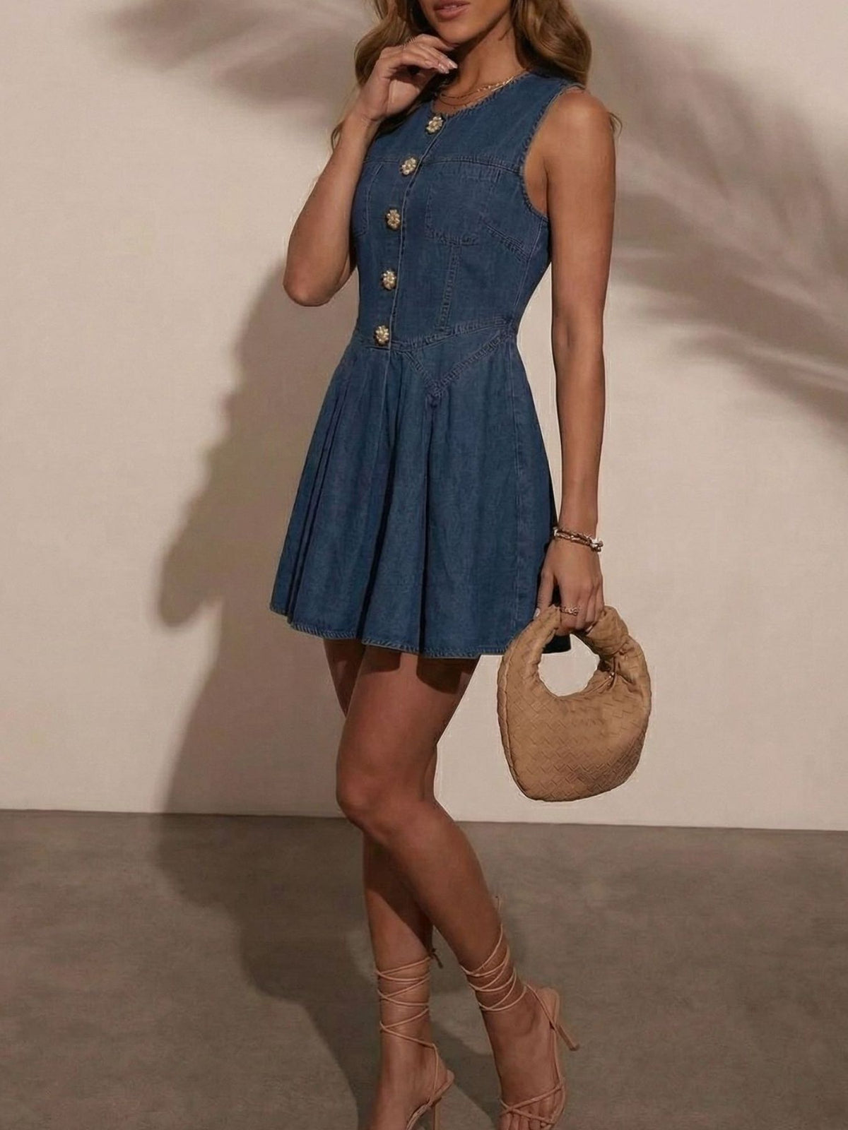 Women's sleeveless denim mini dress by Plush Fashion Hub featuring a button-front design and stretchy cotton blend fabric.