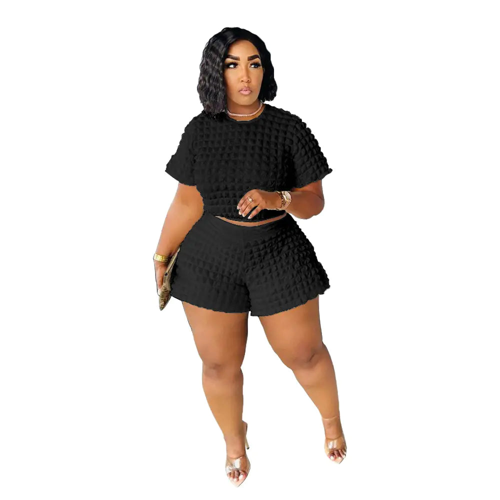 Plus size women's casual summer two-piece set featuring trendy shorts and top, styled for comfortable, relaxed wear.