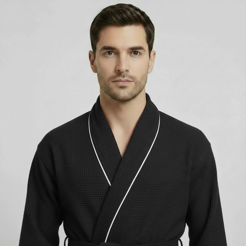Front view of Lotus Linen men's premium waffle piping robe in small black with contrasting piping.