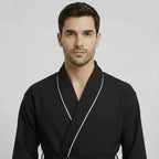 Front view of Lotus Linen men's premium waffle piping robe in small black with contrasting piping.