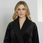 Front view of Lotus Linen women's ultra-soft plush bathrobe in small black, showcasing cozy, plush fabric and relaxed fit.