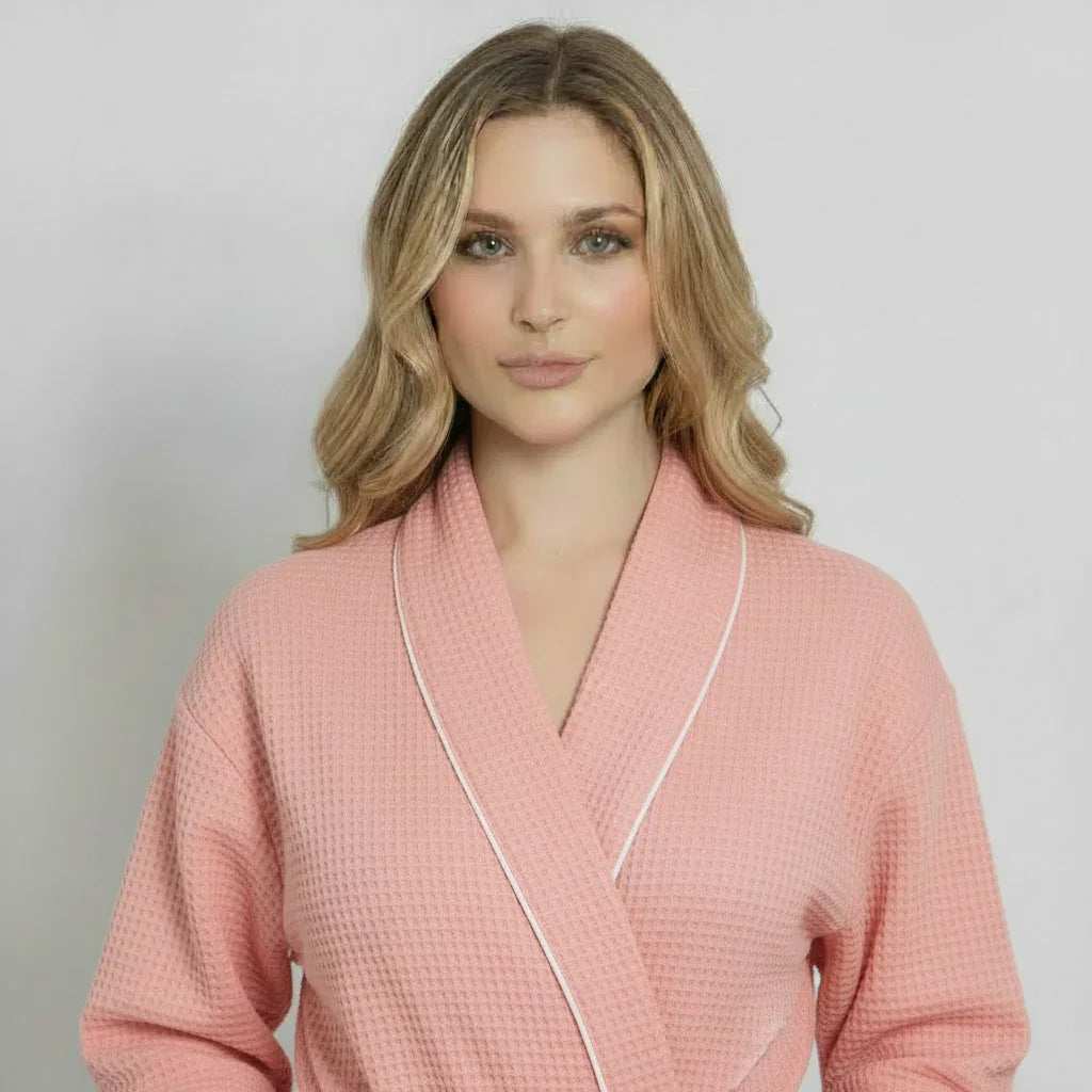 Light pink women's waffle piping bathrobe by Lotus Linen, lightweight spa-style robe with front design and piping details.