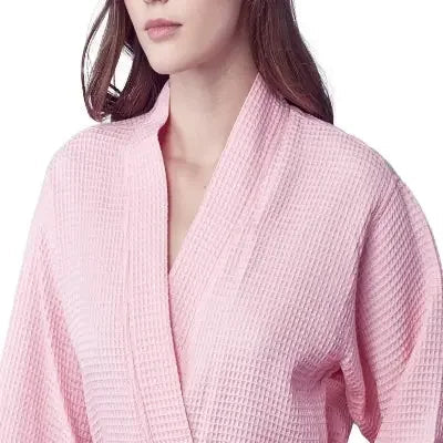 Front view of Lotus Linen women's knee-length waffle robe in blush, showcasing soft fabric and cozy design.