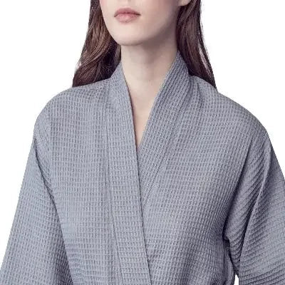 Front view of Lotus Linen women's knee-length waffle robe in small grey kimono style, soft textured fabric, cozy and comfortable.