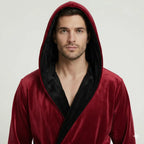 Front view of Lotus Linen men's hooded robe in burgundy and black, made from ultra-soft plush fabric for daily comfort.