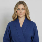 Front view of Lotus Linen women's navy knee-length waffle robe with long sleeves and a tie belt.