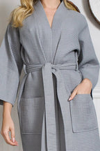 Knee-length waffle robe for women by Lotus Linen, shown hanging with a cozy, textured fabric and relaxed fit for comfort.
