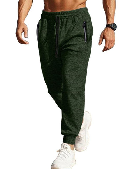 Men's slim fit sports trousers with zipper cuffs and slant pockets in dark green.