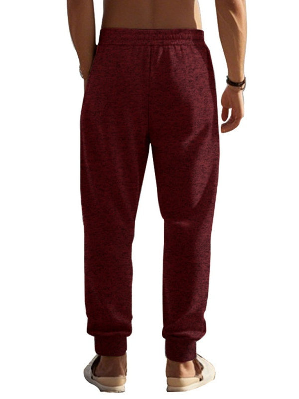 Men's sports trousers in maroon, cationic fabric with zipper cuffs, slim fit design.