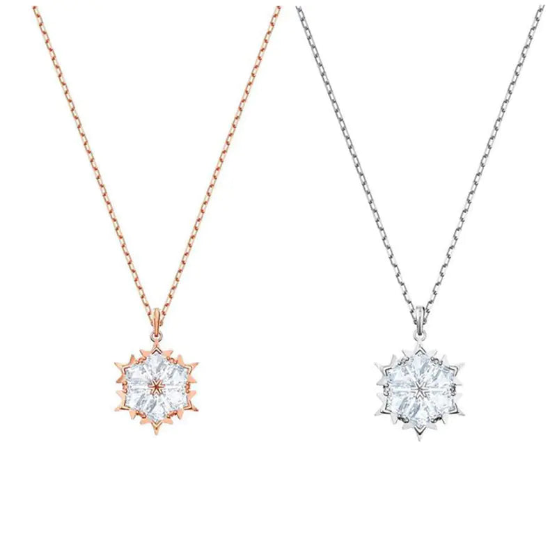 Snowflake necklace with silver chain and diamond pendant, featuring a delicate, sparkling winter-inspired design.