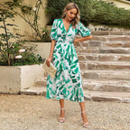 Summer floral V-neck dress for women by Dukun Design, featuring a vibrant print and flowing fabric.
