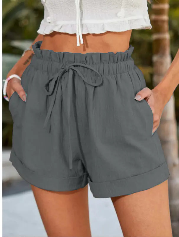 Light beige minimalist women's drawstring shorts with side pockets, designed for comfort and casual wear.