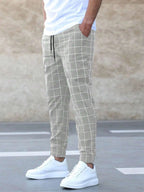 Men's plaid print drawstring trousers by FitiqueFit, casualwear with a comfortable fit and stylish plaid pattern.