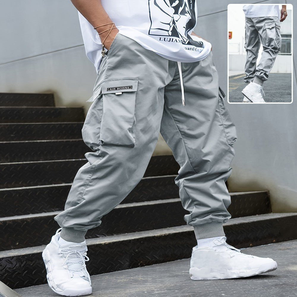 Men’s multi-pocket drawstring cargo pants from FitiqueFit, featuring a streetwear style with multiple functional pockets.