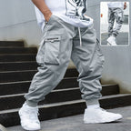 Men’s multi-pocket drawstring cargo pants from FitiqueFit, featuring a streetwear style with multiple functional pockets.