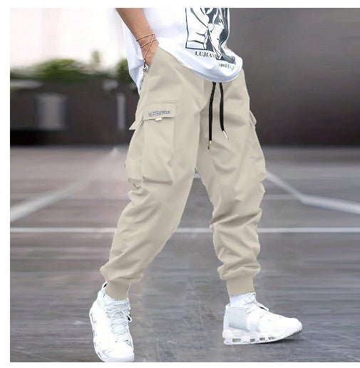 Men's multi-pocket drawstring cargo pants in streetwear style by FitiqueFit with multiple front and side pockets.