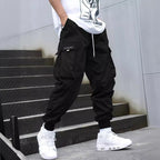 Men’s multi-pocket drawstring cargo pants from FitiqueFit, streetwear style with multiple pockets and adjustable drawstring waist.