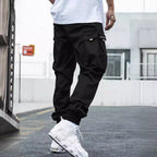 Men’s streetwear cargo pants with multiple pockets, drawstring waist, casual fit, by FitiqueFit, shown in neutral color