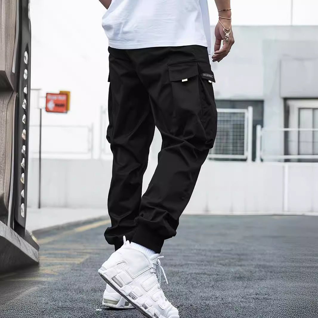 Men’s streetwear cargo pants with multiple pockets, drawstring waist, casual fit, by FitiqueFit, shown in neutral color