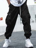 Men's streetwear cargo pants with multiple pockets and drawstring waist, by FitiqueFit, shown in a casual urban style.