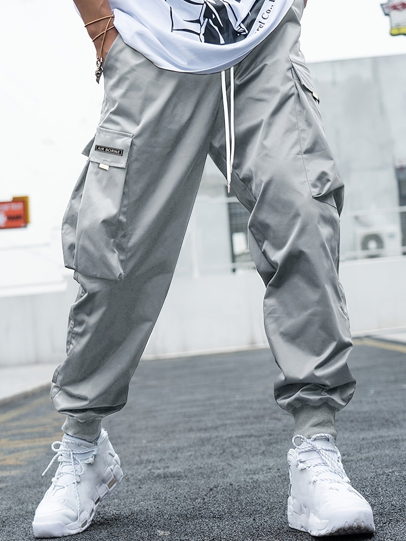 Men’s multi-pocket drawstring cargo pants from FitiqueFit, streetwear style with multiple pockets and adjustable drawstring waist.
