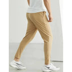 Men's black quick-dry running joggers from FitiqueFit, casualwear with breathable fabric and athletic fit, displayed on a model.