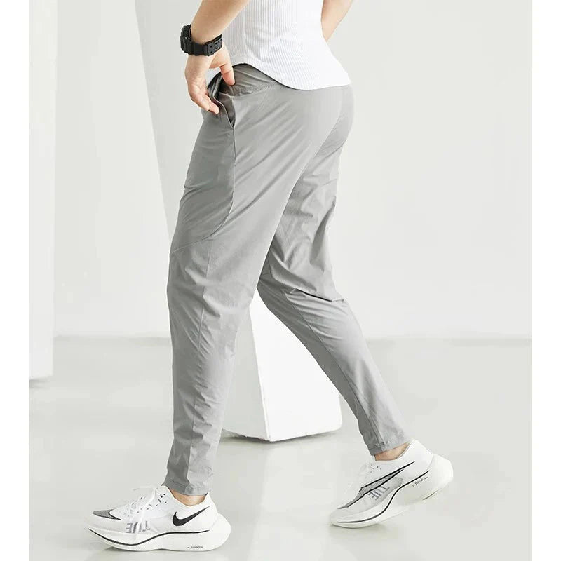 Black men's quick-dry running joggers by FitiqueFit, casualwear athletic pants with breathable fabric for active wear.