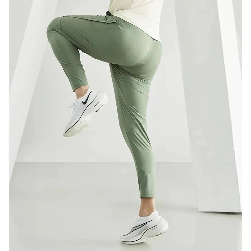 Men's black quick-dry running joggers by FitiqueFit, casualwear style, showing the lightweight fabric and relaxed fit.