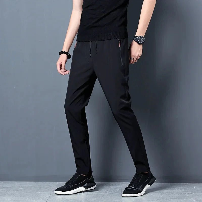 Men's stretch slim fit cargo jogger pants by FitiqueFit featuring an elastic waistband and casual style, shown in dark gray fabric.