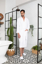 Men's waffle spa bathrobe by Lotus Linen, lightweight and absorbent, shown hanging with a relaxed fit and textured waffle fabric.