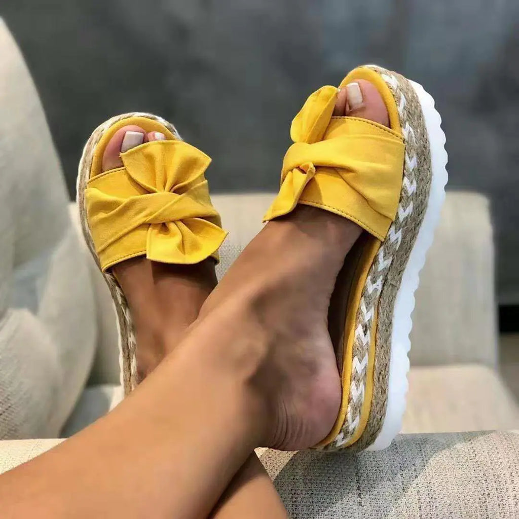 Women’s bow sandals with platform wedge heel in a stylish design, featuring feminine bow detail and comfortable sole.