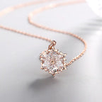 Silver snowflake necklace with diamond pendant, featuring a delicate chain and sparkling gemstone detail.