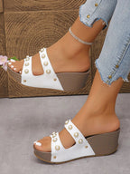Women's pearl-embellished wedge sandals with mid-height heel and comfortable design, ideal for dressy occasions.