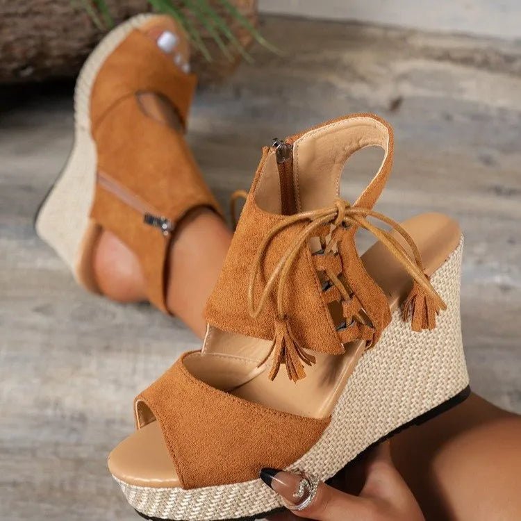 Tan bohemian peep toe wedge sandals with lace-up design and tassel details, stylish trendy shoes for casual wear.