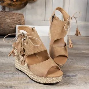 Bohemian tan peep toe lace-up wedge sandals with tassel details, stylish summer shoe by Trendsi.