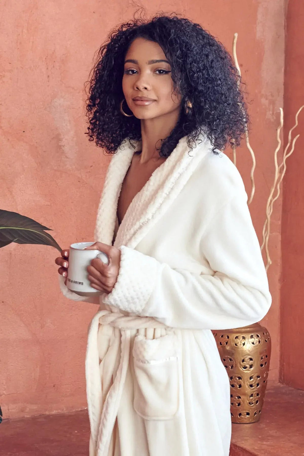 Women's ultra soft plush bathrobe from Lotus Linen, shown in a cozy, fluffy fabric with a hood and tie waist for comfort.