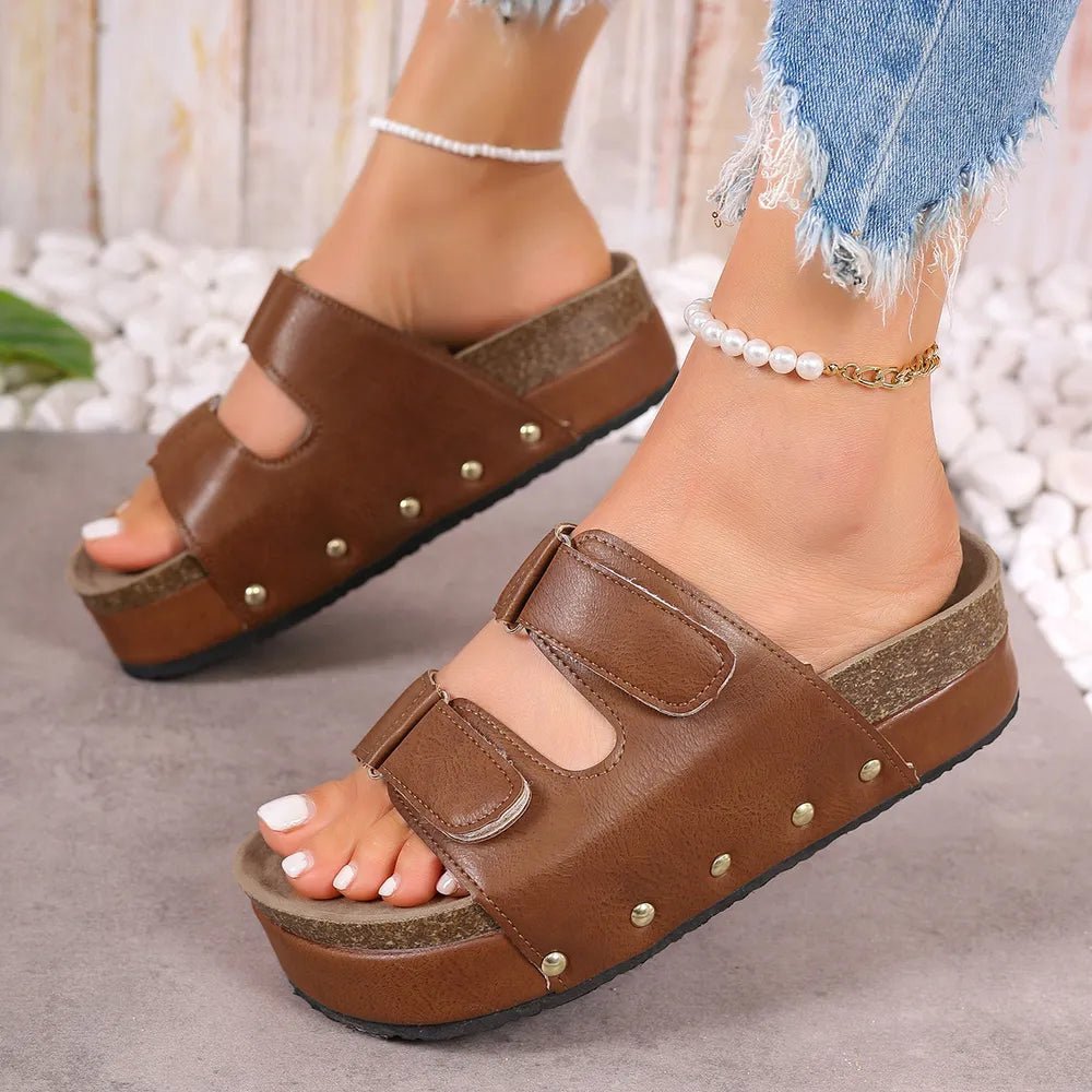 Women's studded platform sandals made of PU leather with a stylish design, featuring ankle straps and a chunky heel.