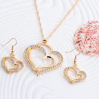 Double heart earrings and matching necklace wedding set featuring silver-tone jewelry with elegant heart designs.
