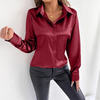 Real shot of a women's satin summer shirt from Bella Mia, featuring a smooth artificial silk fabric and stylish design.