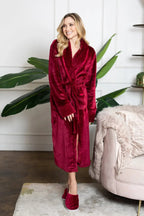Red Lotus Linen women's ultra-soft plush bathrobe hanging open, showing cozy collar and long sleeves.