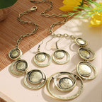 Retro oil-dropped hollow round earrings and matching women's necklace in jewelry set, featuring vintage-inspired design.