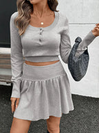 Women's ribbed long sleeve top and pleated knit skirt two-piece set, stylish women's apparel from Trendsi.