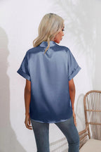 Women’s short sleeve satin shirt by Bella Mia featuring a casual, loose fit with button details and a smooth satin finish.