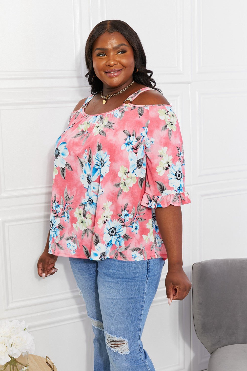 Floral cold-shoulder three-quarter sleeve top with metal ring details, women's apparel by Plush Fashion Hub.