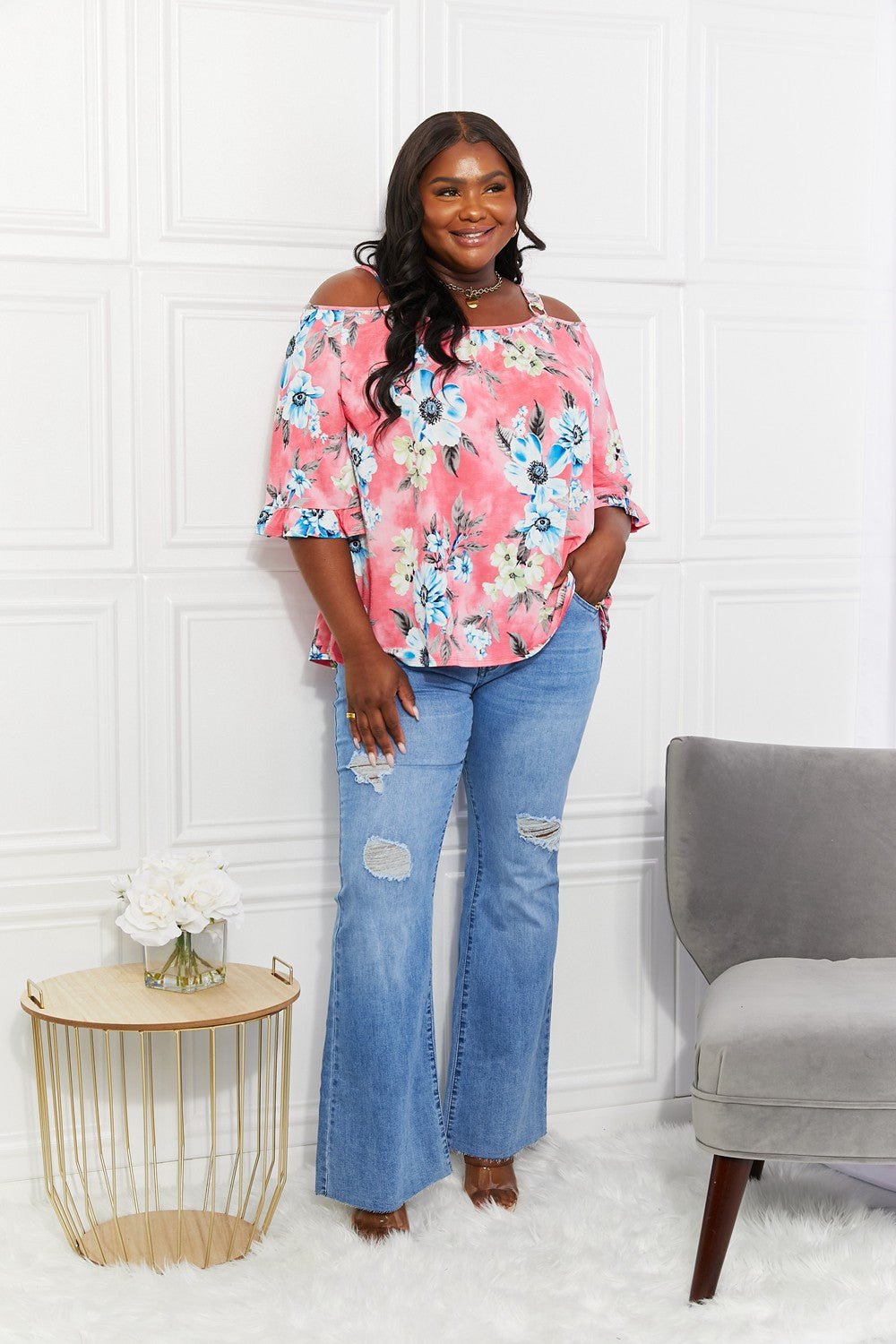 Floral cold-shoulder three-quarter sleeve women's top with metal ring details, stylish and fresh from Plush Fashion Hub.